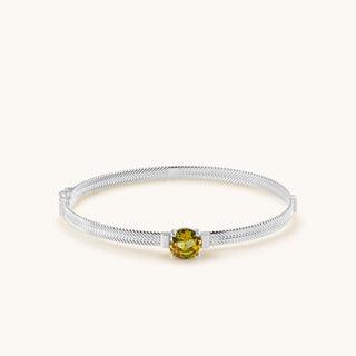 Bangle in sterling silver with champagne yellow Diaspore, laid flat