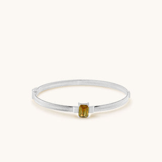 Bangle in sterling silver with champagne yellow Diaspore, laid flat