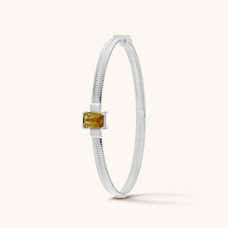 Bangle in sterling silver with champagne yellow Diaspore, upright view