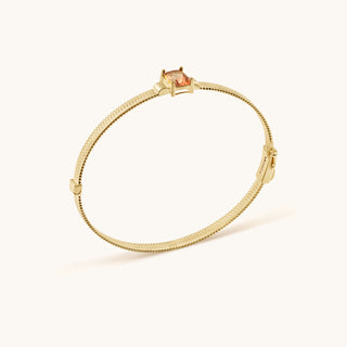 Bangle in gold-plated sterling silver with lychee pink Diaspore, side view